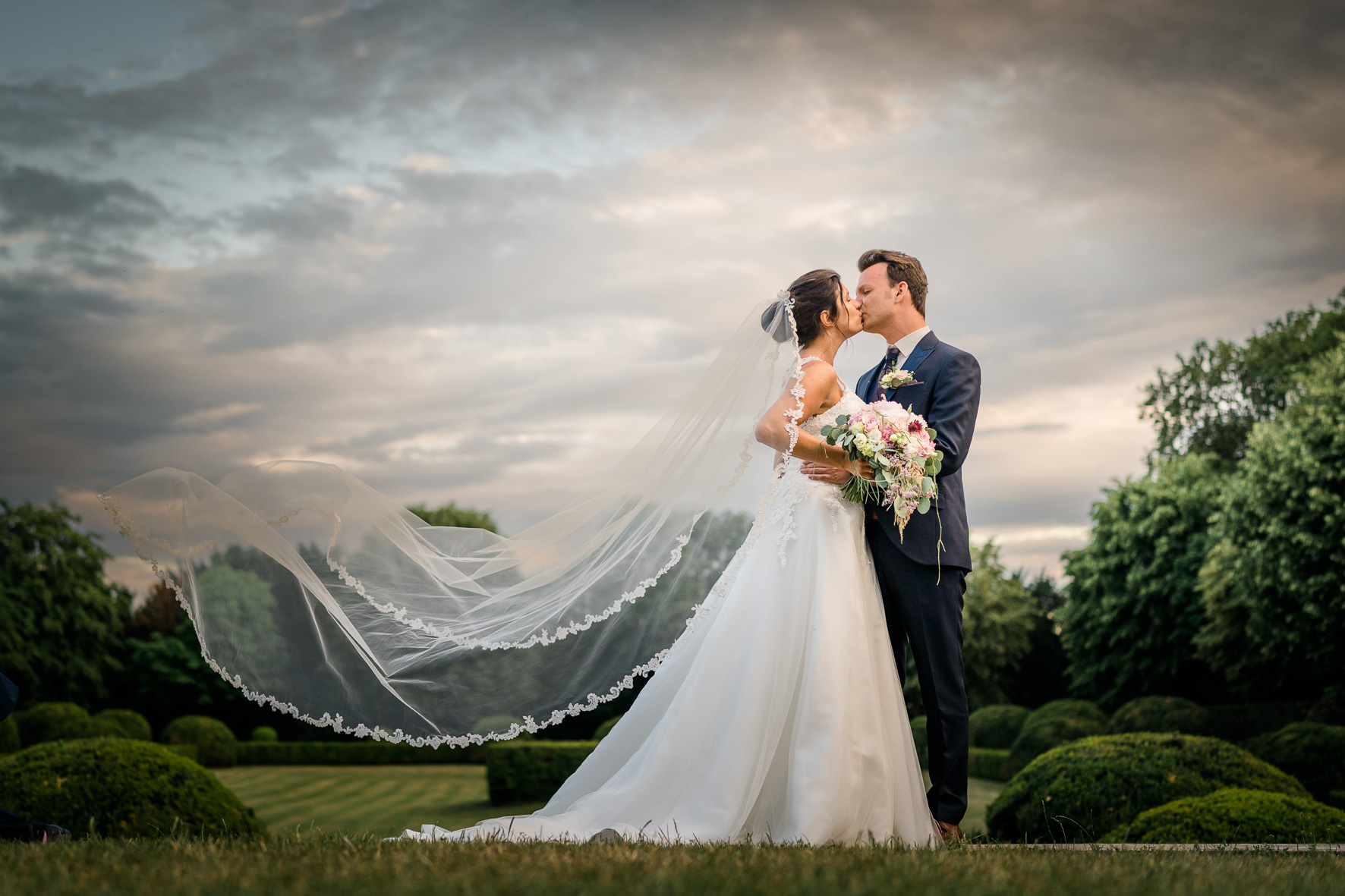 Bride and Groom sharing a romantic kiss as the sun sets