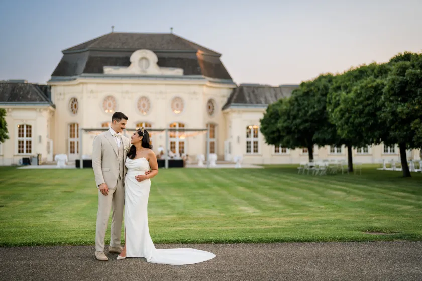 Bridal couple after the wedding in front of the wedding location Laxenburg Palace